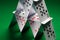 Close up of house of playing cards on green cloth