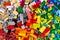 Close-up of huge pile of stackable plastic toy bricks top view.  Colorful texture childhood education and development concept
