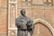 Close-up on Hugo de Groot Monument dating from 1886 with Nieuwe Kerk clock tower in the background, Delft