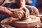 Close up human arms palms unrecognizable male female pottery master hands sculpt vase pot jug experienced workshop