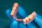 Close-up human denture of the upper jaw on a blue background in the hand of a dentist wearing a medical glove