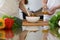 Close-up of human hands cooking in a kitchen. Friends having fun while preparing fresh salad. Vegetarian, healthy me