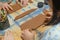 Close up of human hands making a clay mug. Pottery teaching class. Potter makes dishes from clay, ceramics