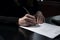 Close-up human hands view of businesswoman signing documents. Generative AI