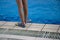 Close up human legs swimmer fins near pool