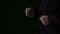 Close up of hurry businessman in suit runing, slow motion. Low key dark background.