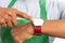 Close-up of hypermarket employee pointing wristwatch