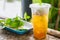 Close up of ice cold Longan fruit juice in glass with straw on old table