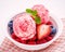 Close Up ice cream mixed berry fruits raspberry ,blueberry ,strawberry and peppermint leaves setup in white bowl on white wooden
