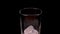 Close-up of ice cubes falling into an empty glass on black background, slow motion. Empty glass with ice cubes on a