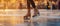 Close-up of ice skater& x27;s boots on frozen pond ice rink, winter sunset festive bokeh background