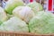 Close up of iceberg lettuce being sold at a farmer`s market, in a pile