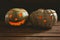 Close up of illuminated jack o lanterns on table during Halloween