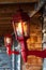 Close up of illuminated red vintage lanterns at the entrance of wooden cabin