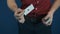 Close up illusionist in red shirt showing playing cards magic focuses