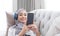 Close-up image, Attractive Muslim woman using a smartphone in living room, chatting with her friends or scrolling on