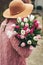 Close up image of beautiful tulips bouquet holding by young girl