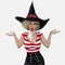 Close up image of a beautiful young blond female witch surprised with her hands up shrugging on an isolated white background