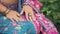 Close-up image beautiful young female hands. Hand woman gently touches Indian vintage national pink blue saree dress