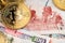 Close up image of Bitcoin Cryptocurrency coins and Kenyan Shilling Banknotes