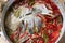 Close-up image of boiled tilapia with fresh red pepper, Thai food, hot pot