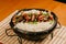 Close-up image of a bowl of steaming hot rice and beef served in a bowl