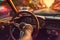 A close-up image of a driver\\\'s hand firmly gripping the steering wheel as their car overtakes, with a blurred background,