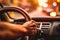 A close-up image of a driver\\\'s hand firmly gripping the steering wheel as their car overtakes, with a blurred background,