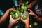 Close-up image of female hands holding glasses with mojito cocktails, Happy friends group cheering mojito drinks at cocktail bar