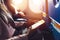 Close-up image of female hands holding smartphone sitting in the airplane