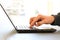 Close-up image of a finger touching texting on keyboard on a laptop computer. Stock photo with white background for copy