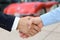 Close-up image of a firm handshake after a successful deal of b