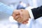 Close-up image of a firm handshake between two colleagues on a