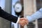 Close-up image of a firm handshake between two colleagues in of