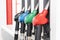 Close up image of four gas pumps with different types of fuel on gas station
