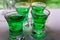 Close up image of four schnapps glases with green booze