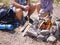 Close-up image of friends hands start fire with magnesium fire steel, fire striker.