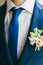 Close-up image of a groom in a blue tie. Artwork. Selective focus on the ornament tie