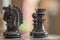 Close-up image of hand carved, ebony wooden chess pieces at the start of a chess match.