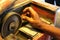 Close up image of hands of a person cutting a gemstone