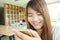 Close-up image of hipster girl sitting at vintage cafe and using modern smarphone, female hands typing message on mobile phone.