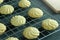 Close up image homemade butter cookies put on wire rack with wooden tray on the table.