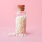 Close-up image of homeopathic globules in glass bottle on pastel pink background. Alternative homeopathy medicine herbs,