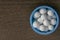 Close-up image of Homeopathic substance bottle cap consisting of pills on wood background