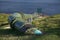 Close up image of huge industrial green metal pipe, running into water