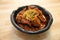 Close up image of Korean food, Braised Short Ribs Galbi Jjim, on a bowl and wooden table