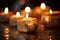 close-up image of lit candles in a kinara