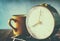 Close up image of old clock and cofee cup over wooden table. image is filtered with retro faded style