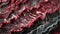 A close up image of a piece of raw meat. The meat is red and juicy, with a marbled texture