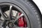 Close up image of racing sport car`s wheel with red break dish.